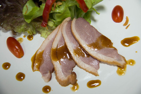 Smoked duck and fresh vegetable salad with sauceの写真素材