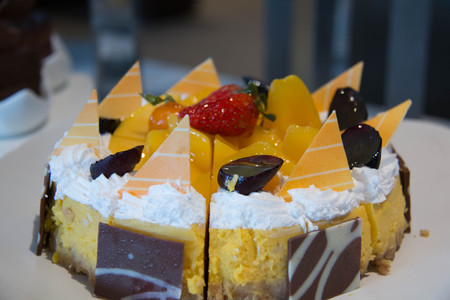 Cheese cake with mango in close up.の写真素材