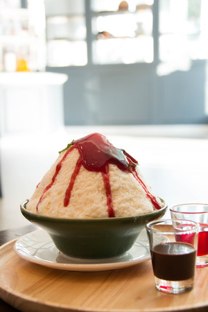Milk Bingsu shaved ice strawberry syrup topping  Korean dessertの写真素材