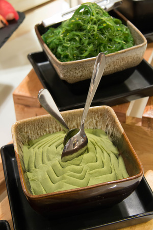 Wasabi paste on ceramic bowle on woodの写真素材