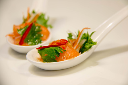 spicy salmon salad - fushion food in spoonの写真素材
