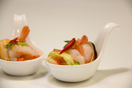 yummy seafood spicy salad in white spoonの写真素材