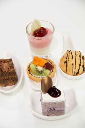 Assorted mini cakes sweet dessert, chocolate and fruit 
の写真素材