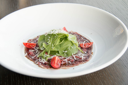 Delicious beef carpaccio with sliced on white plateの写真素材