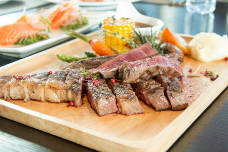 Grilled Tomahawk Beef steak with vegetable and sauceの写真素材