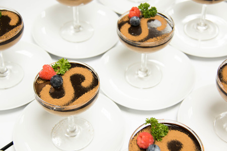Chocolate mousse in a glass on top cocoa powder