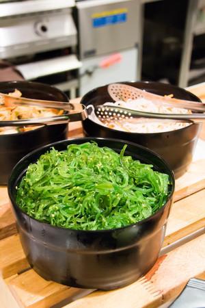 A delicious fresh seaweed salad on buffetの写真素材