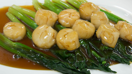 seared scallops, garnished with served on a bed of asparagusの写真素材