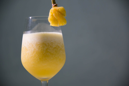 A Glass with delicious pineapple juice on tableの写真素材