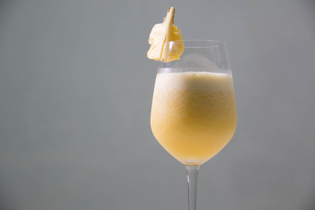 A Glass with delicious pineapple juice on table