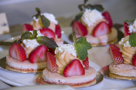 Delicious sweet cakes and pastry at wedding dessert table reception