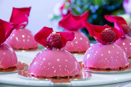 Delicious sweet cakes and pastry at wedding dessert table reception