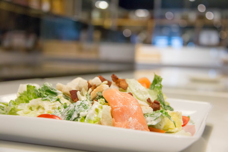A Caesar salad with salmon and parmesan cheeseの写真素材