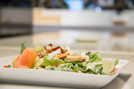 A Caesar salad with salmon and parmesan cheeseの写真素材