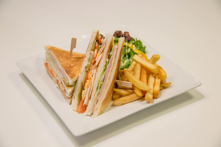 A Chicken club sandwich with french friesの写真素材