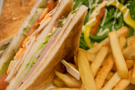 A Chicken club sandwich with french friesの写真素材