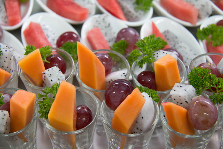 Close up of fresh mixed fruit on white cupの写真素材