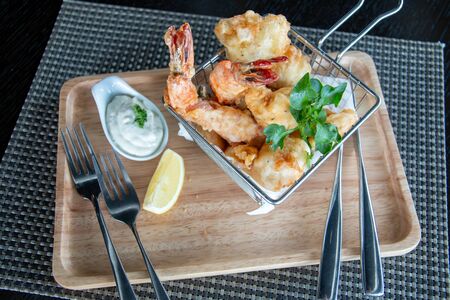 A deep fried seafood in a basket の写真素材