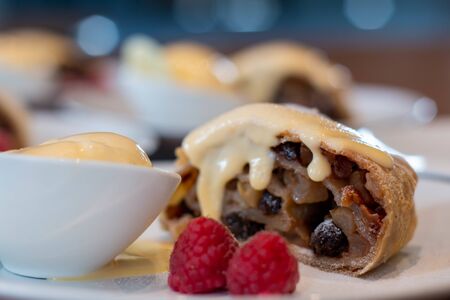 A apple strudel with vanilla sauce on plateの写真素材