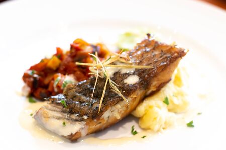 A snow fish steak on white plate