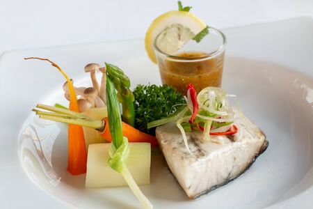 A snow fish steak with sauce on plate