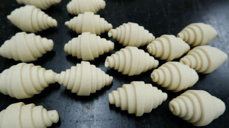 A croissant dough on black table