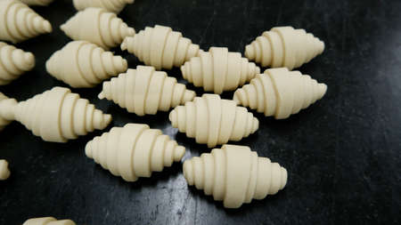 A croissant dough on black tableの写真素材