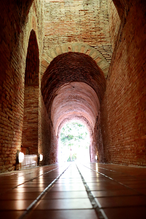 The old tunnel with a light in the end at Wat Umong Changmai Thailand.の写真素材
