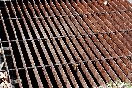 Gutters drain grate, drain cover. Road drains - sewer cover. iron grate of water drain on the road...