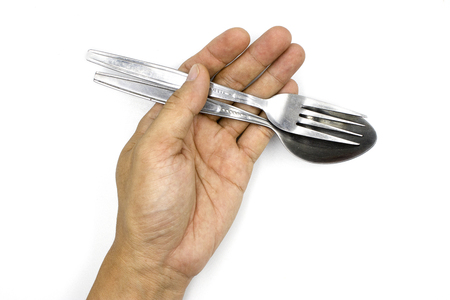 A male hand holding spoon and folk , man hand  isolated on white background High resolution image...