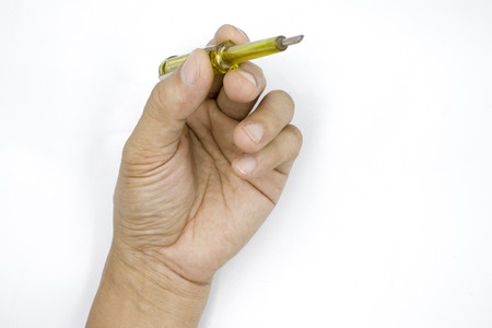 Male hand holding electric tester screwdriver to check the electrical , Test light, man hand isolated on white background High resolution image gallery.の写真素材
