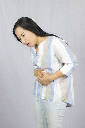 Pain stomach. Woman having painful stomachache,Female suffering from abdominal pain High resolution image gallery.の写真素材