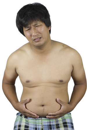 fat man touching his stomach, Fat man with a big belly isolated on white background  High resolution image gallery.の写真素材