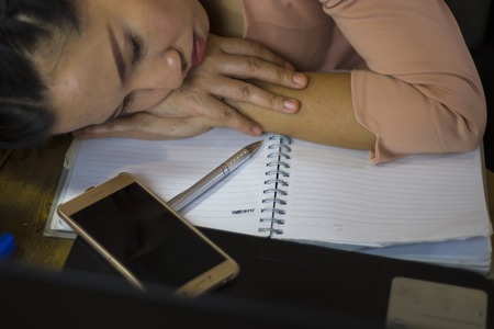 Asian woman worker suffering from hurt,fatigue, pain at neck, muscle, stressed during working with...
