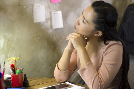 Asian woman worker suffering from hurt,fatigue, pain at neck, muscle, stressed during working with laptop for a long time,の写真素材