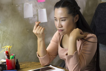 Asian woman worker suffering from hurt,fatigue, pain at neck, muscle, stressed during working with...