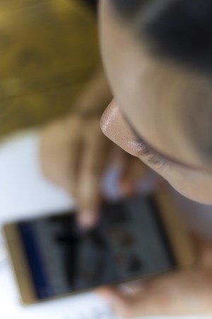 Asian woman worker suffering from hurt,fatigue, pain at neck, muscle, stressed during working with laptop for a long time,の写真素材
