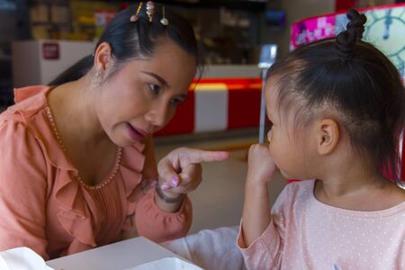 Angry mom with her child,  looking her daughter and complaining. High resolution image gallery.