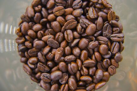 Fresh coffee beans into the glass, Food concept top view copy space.の写真素材