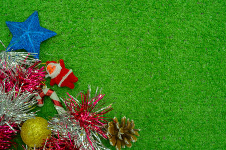 Christmas gift decorated with green branch, pine cone, gift bag red and silver beads garlans on knitting blacket . Xmas or New year green background, Merry Christmas greeting card.の写真素材