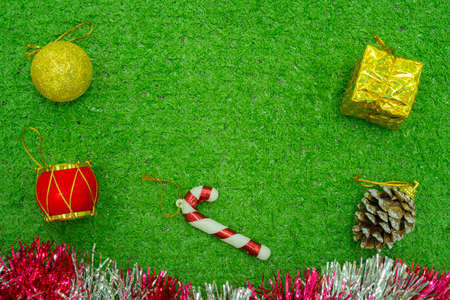 Christmas gift decorated with green branch, pine cone, gift bag red and silver beads garlans on knitting blacket . Xmas or New year green background, Merry Christmas greeting card.の写真素材