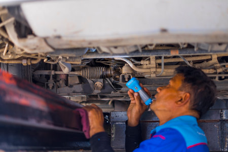 CHIANGMAI,THAILAND-Nov 14, 2019 :  PTT Service center. Mechanic in uniform fixing and Replacement,  wheel alignment a car.のeditorial素材