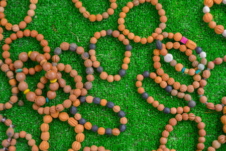 ceramic beads with leather ropes on on green grass. from chiangmai Thailand.の写真素材