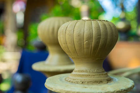 Clay potter creating on the pottery wheel. Sculptor from fresh wet clay on pottery wheel. Selected focus. potter was produced on range of pot in open airの写真素材