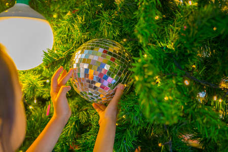Horizontal image close up and selective focus red wrinkle Cristmas ball hanging on Cristmas tree for celebrateの写真素材