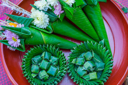 flower in the banana leaf cones with joss-sticks and candle for pray. Northern Thailand culture.の写真素材