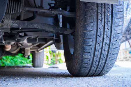 Close up of car tyre tread on the road on a bright day.の写真素材