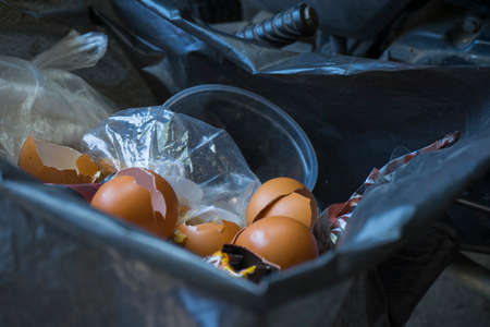 trash bin full of domestic food waste and plastic bag.の写真素材
