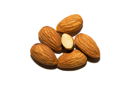 Close-up of almonds. Cut almonds. On white background. Isolated.の写真素材