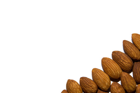 Close-up of almonds. Almonds in the corner. From the side. On white background. Isolated.の写真素材